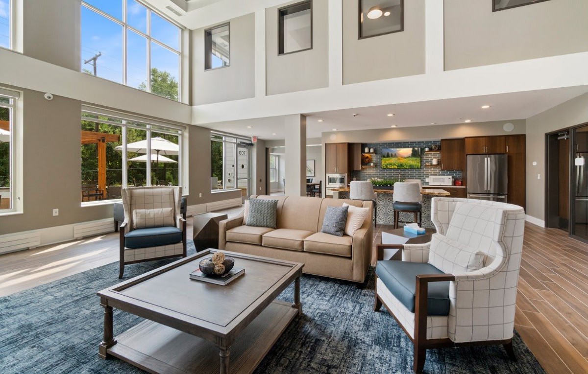 Modern luxury living room with open space and large windows.