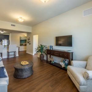 A cozy living room featuring a modern design with a television, comfortable seating, and stylish decor.