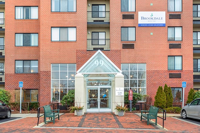Entrance to a hotel with visible signage and symmetrical architectural design.