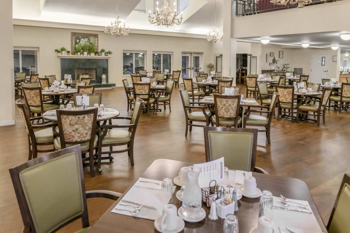 An elegant dining area with neatly arranged tables and chairs, giving a sophisticated ambiance.