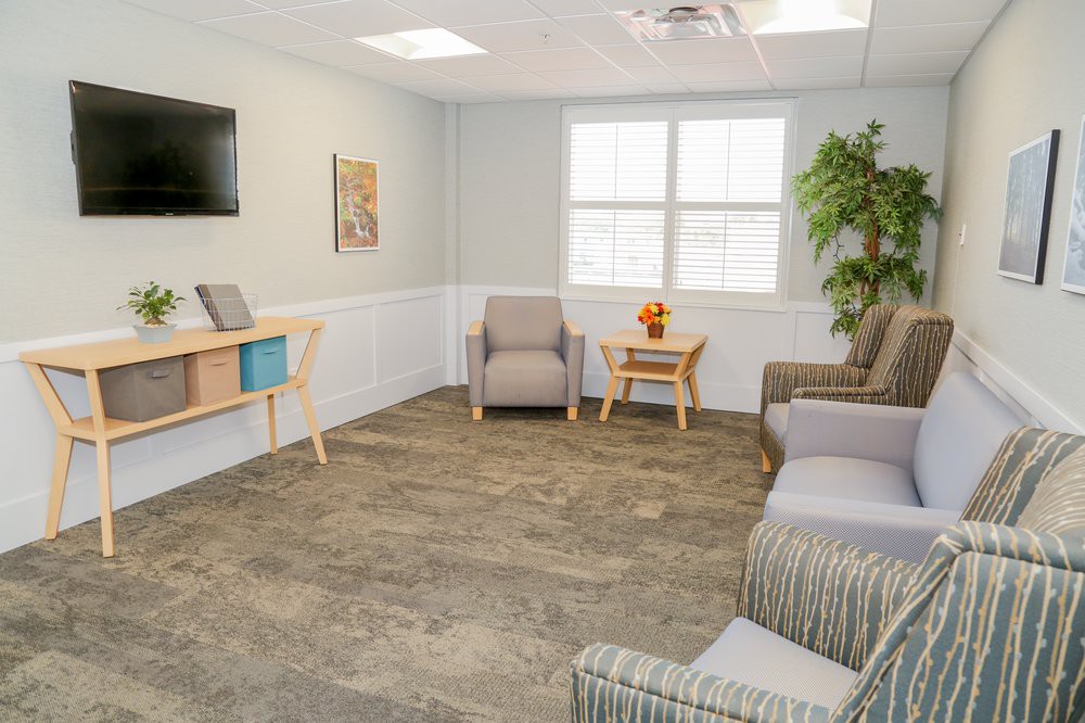 A well-lit waiting room with comfortable seating and modern decor.
