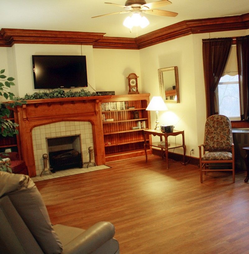 A cozy living room with a fireplace, television, and comfortable seating.