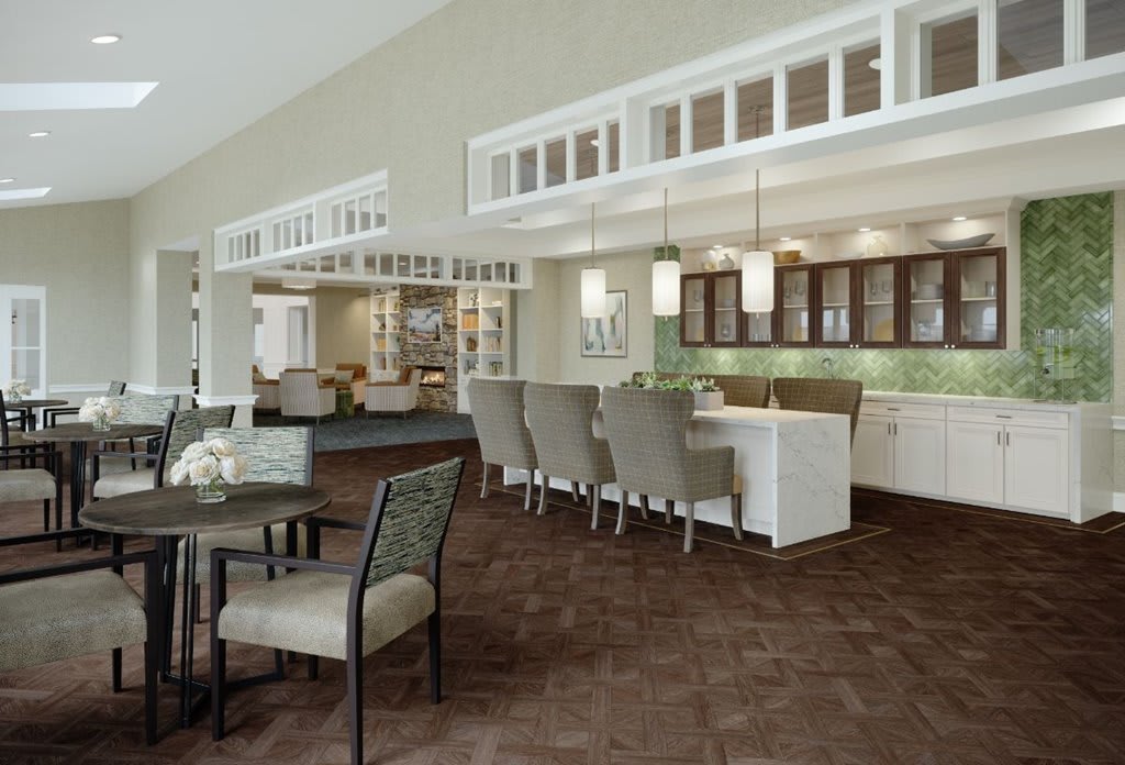 A modern open-plan kitchen and dining area with sleek furnishings.
