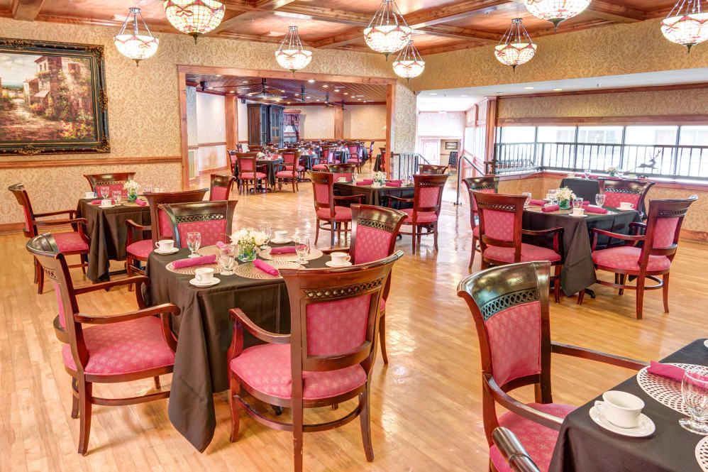 A beautifully decorated dining room with elegantly set tables and comfortable chairs.