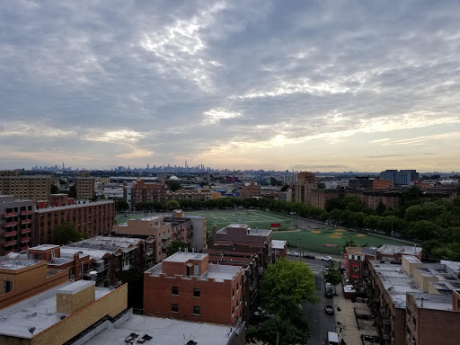 A panoramic view of the city skyline under a cloudy sky.