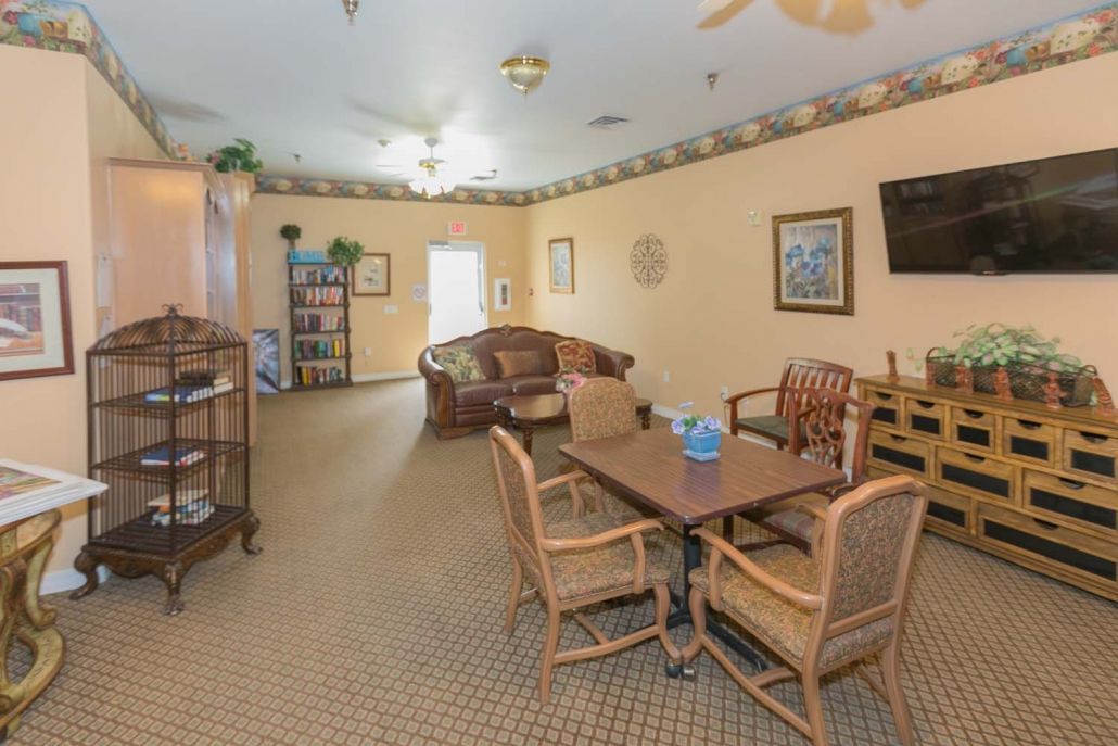 A cozy living room with a sofa, table, chairs, and decorative elements.