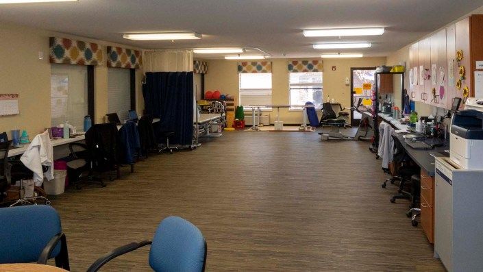 Spacious room with chairs and natural lighting.