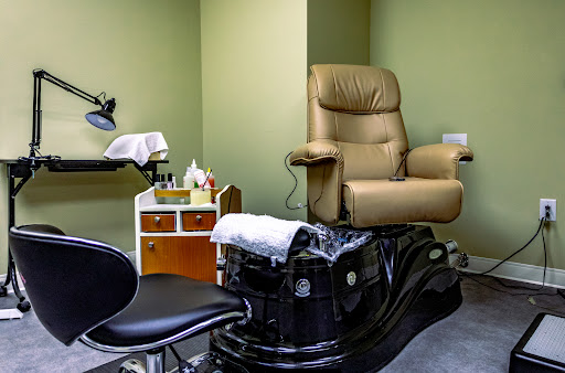 A cozy setup in a nail salon featuring a comfortable pedicure chair and manicure station.