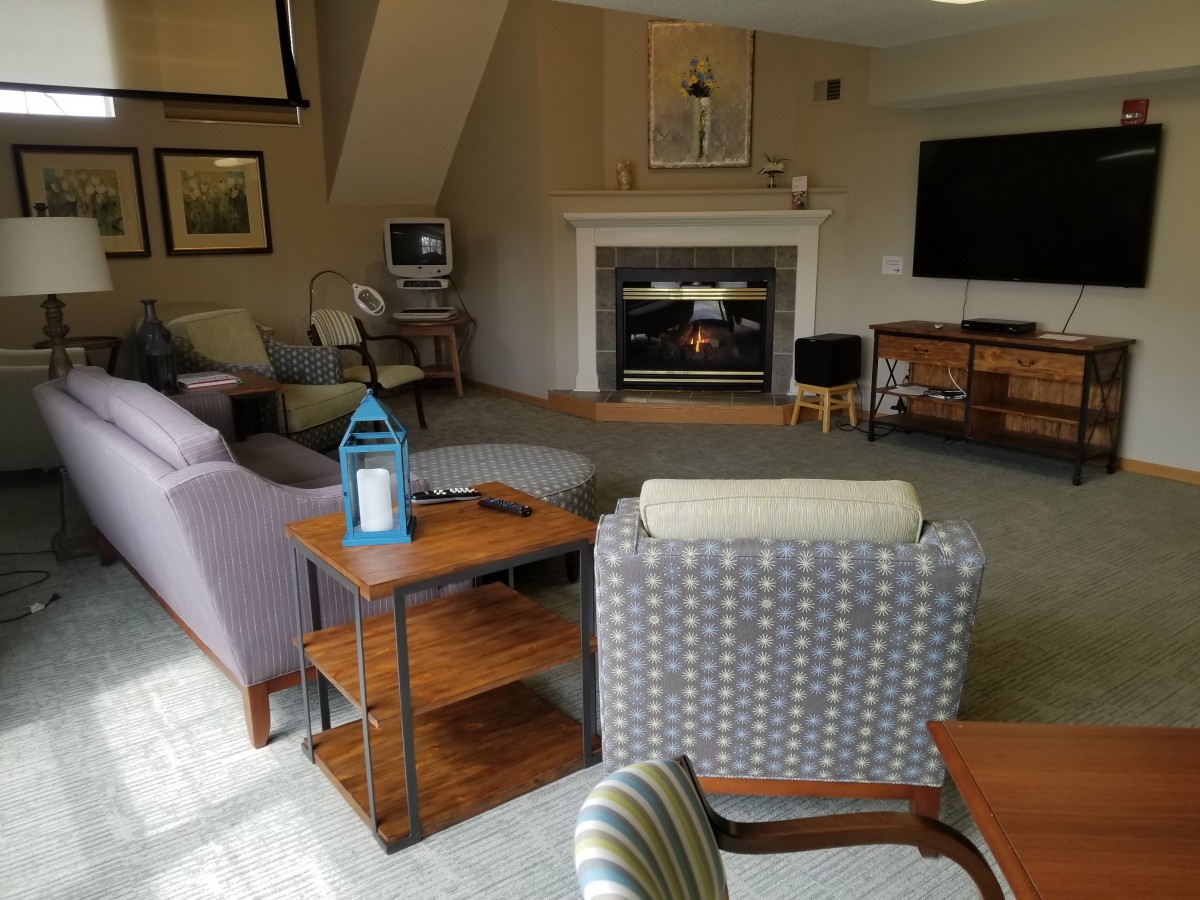 A cozy living room with a fireplace, television, and comfortable seating.