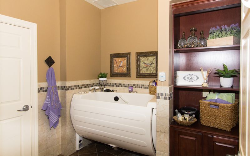 A cozy bathroom with a unique bathtub and decorative elements.