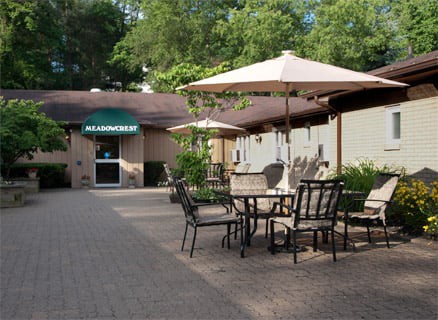 Outdoor seating area with tables and umbrellas at a restaurant.