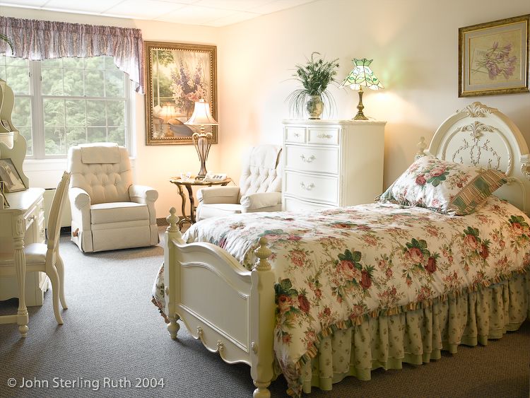 A cozy bedroom with floral decor and classic furniture.