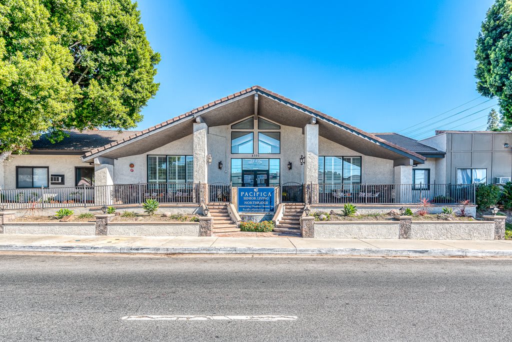 A modern commercial building with a symmetrical design and large glass windows.