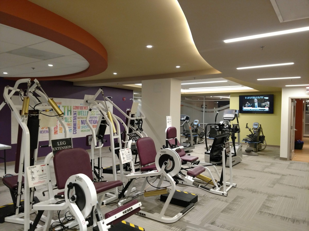 A well-equipped gym with various workout machines and exercise equipment.