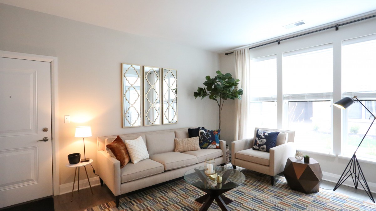 A modern living room with a comfortable sofa, armchair, and stylish decor.