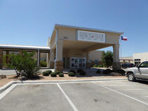 A commercial building with a welcoming entrance and clear signage, set against a clear blue sky.