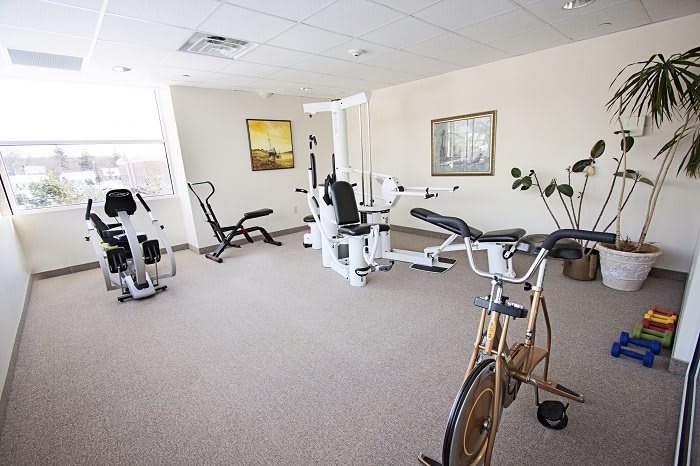A small indoor gym with various exercise equipment.