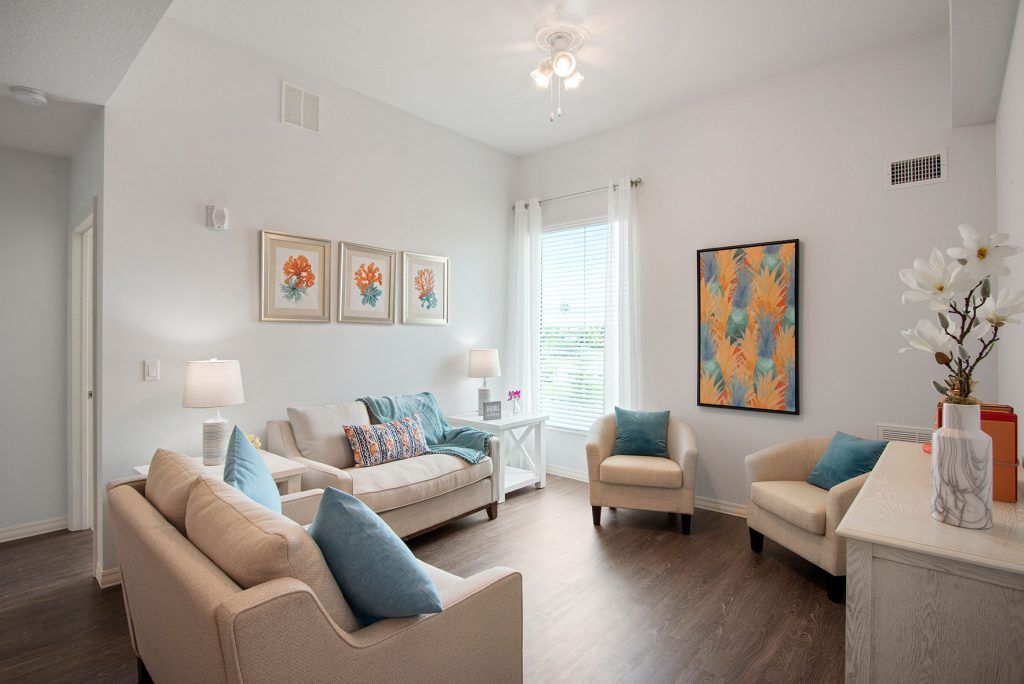 A bright and cozy living room with contemporary furniture and colorful artwork.