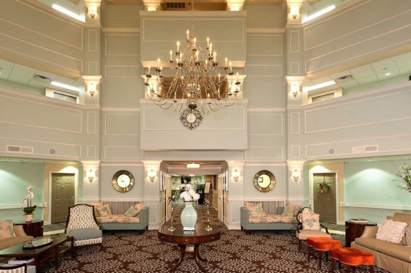 A luxurious hotel lobby featuring a grand chandelier and elegant furnishings.