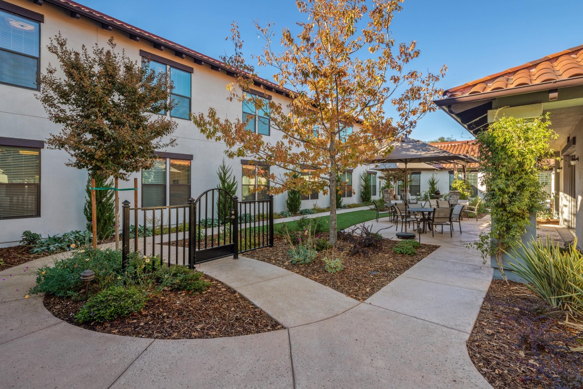 A peaceful courtyard with manicured landscaping and outdoor seating areas.