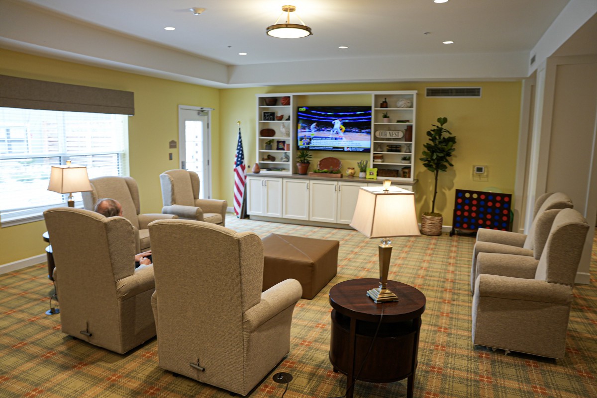A cozy living room with comfortable seating and a large television for entertainment.