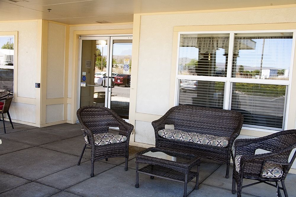 Outdoor patio area with wicker seating and a small table.