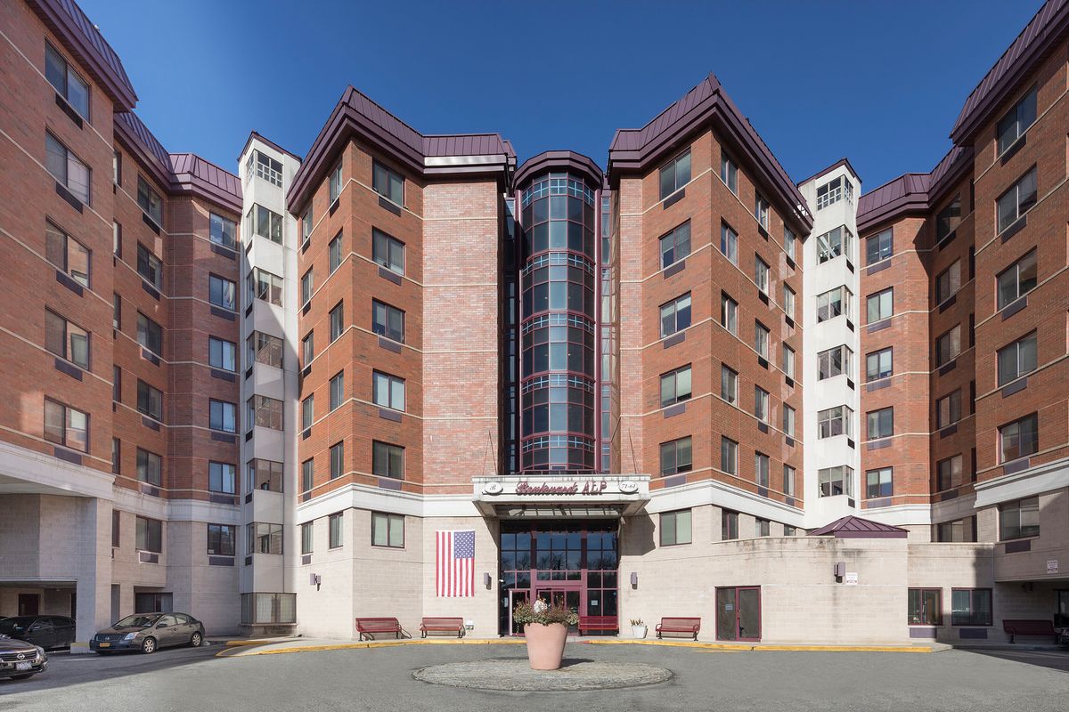 A multi-story residential building with a modern architectural design.