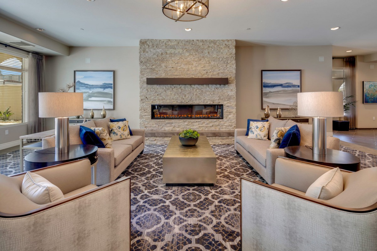 A modern living room featuring elegant sofas, a central coffee table, and a cozy fireplace.