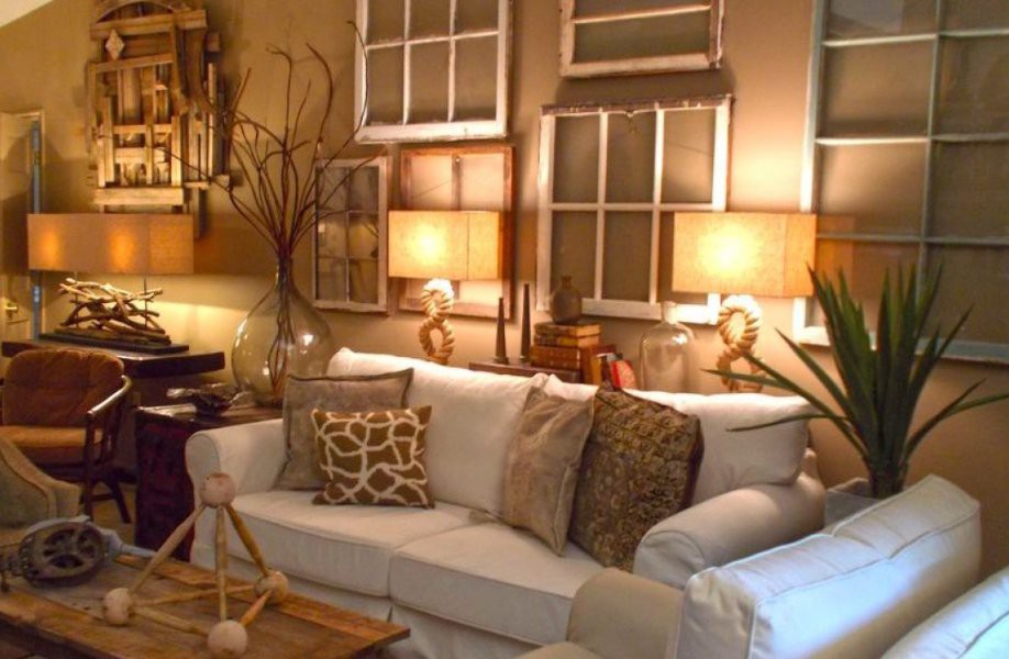 A cozy living room with a white sofa, decorative pillows, and warm lighting.
