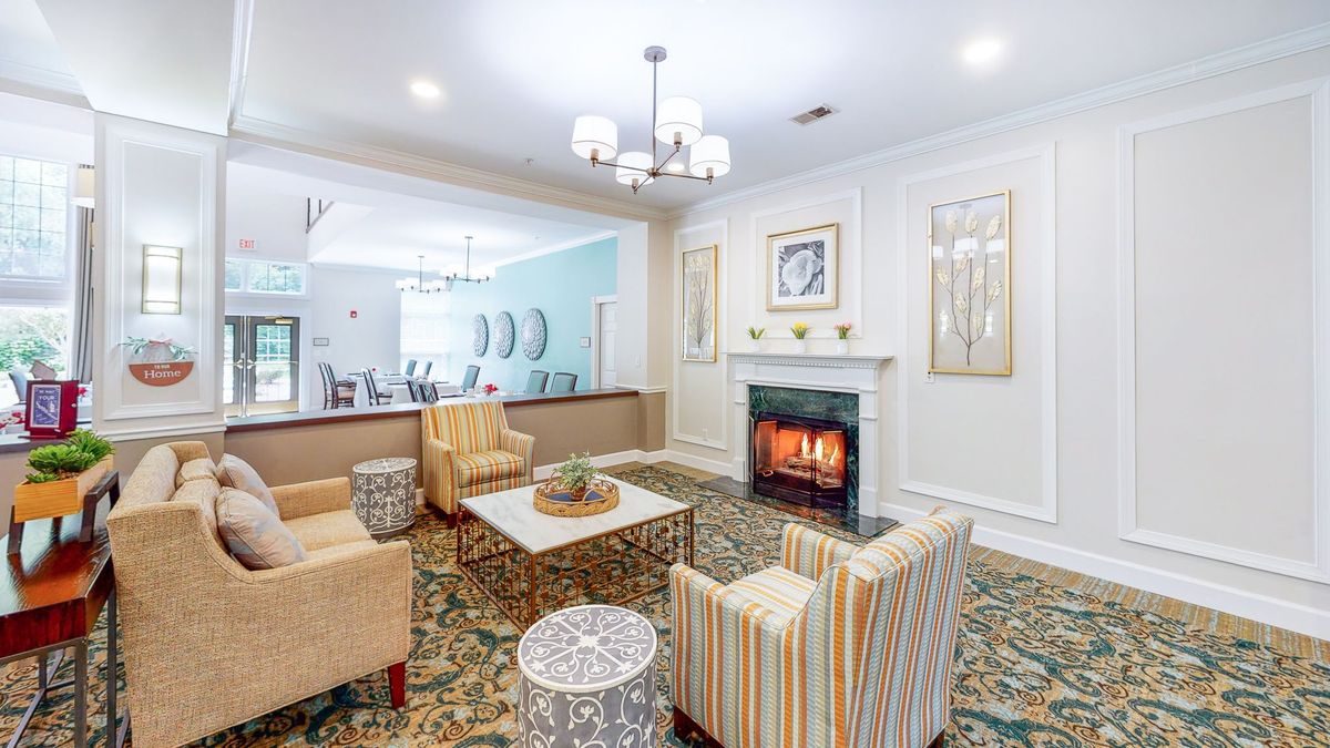 A cozy living room with a fireplace and stylish seating arrangement.
