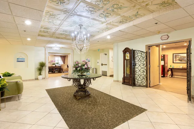 Elegant lobby area with ornate ceiling design and chandelier.