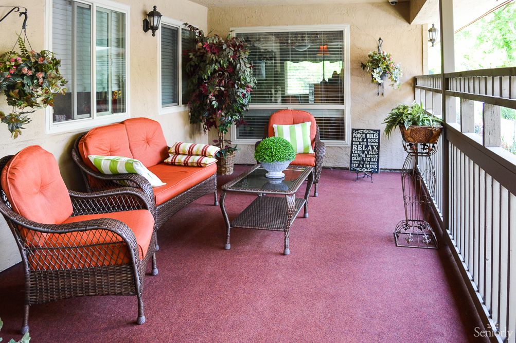 Cozy outdoor patio with wicker furniture and vibrant cushions.