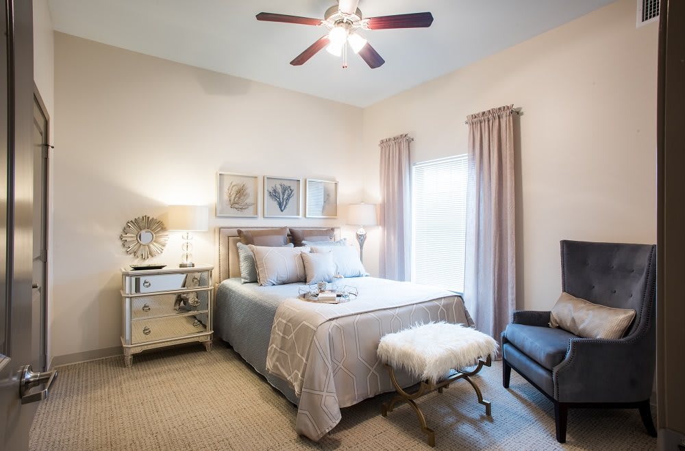 A cozy and elegantly decorated bedroom with a comfortable bed, subtle lighting, and tasteful artwork.