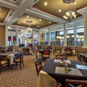 Elegant dining area with chandeliers and well-arranged tables.