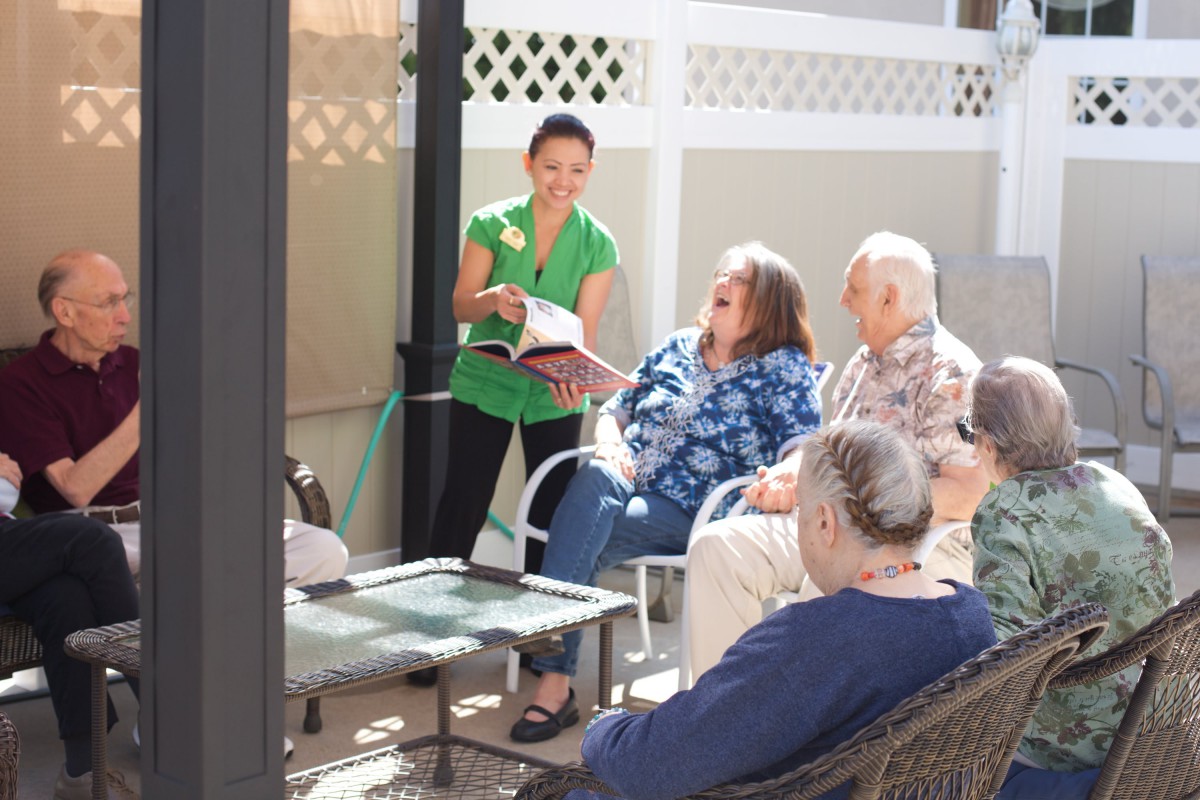 A group of people enjoying a reading session outdoors.