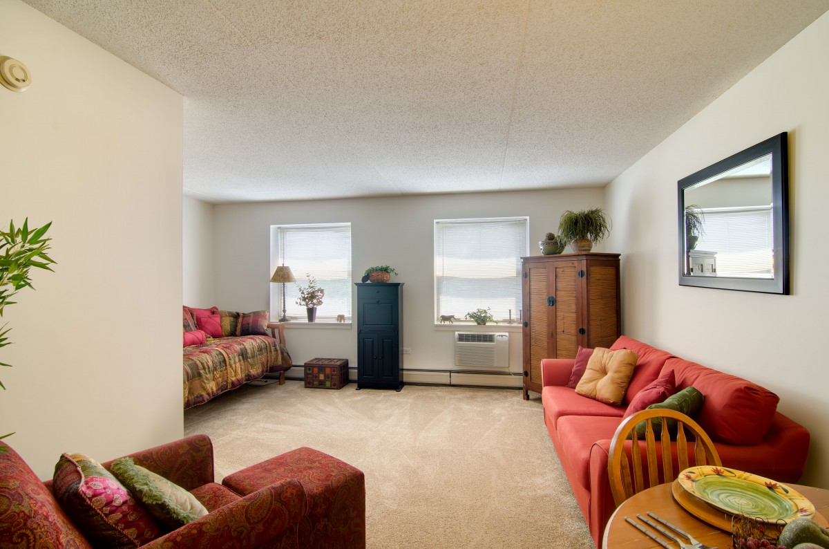 A cozy living room with comfortable seating and natural light from the windows.