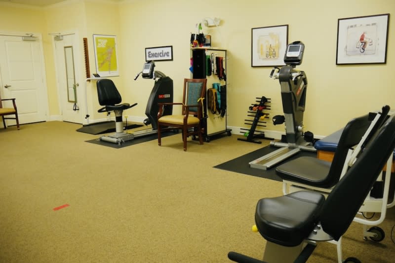 A small fitness room equipped with various exercise machines.