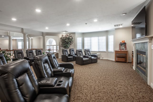 A spacious home theater with multiple reclining chairs arranged for viewing.