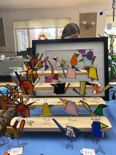 A vibrant display of handcrafted bird figures showcased in a creative arrangement.