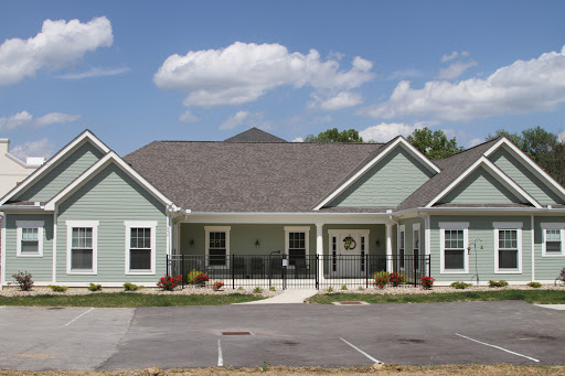 A charming residential building with a well-maintained exterior on a sunny day.