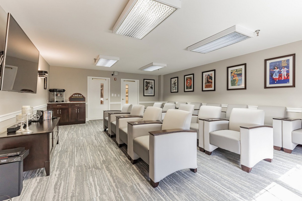 A modern waiting room with comfortable seating and decorative artwork on the walls.