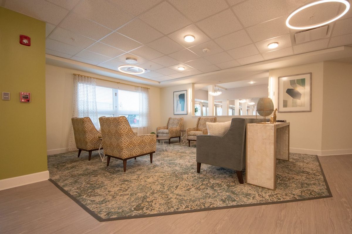 A modern waiting area with comfortable seating and soft lighting.