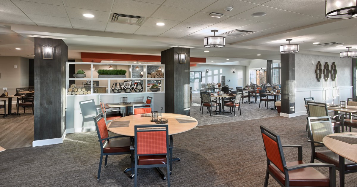 A modern restaurant dining area with neatly arranged tables and chairs.