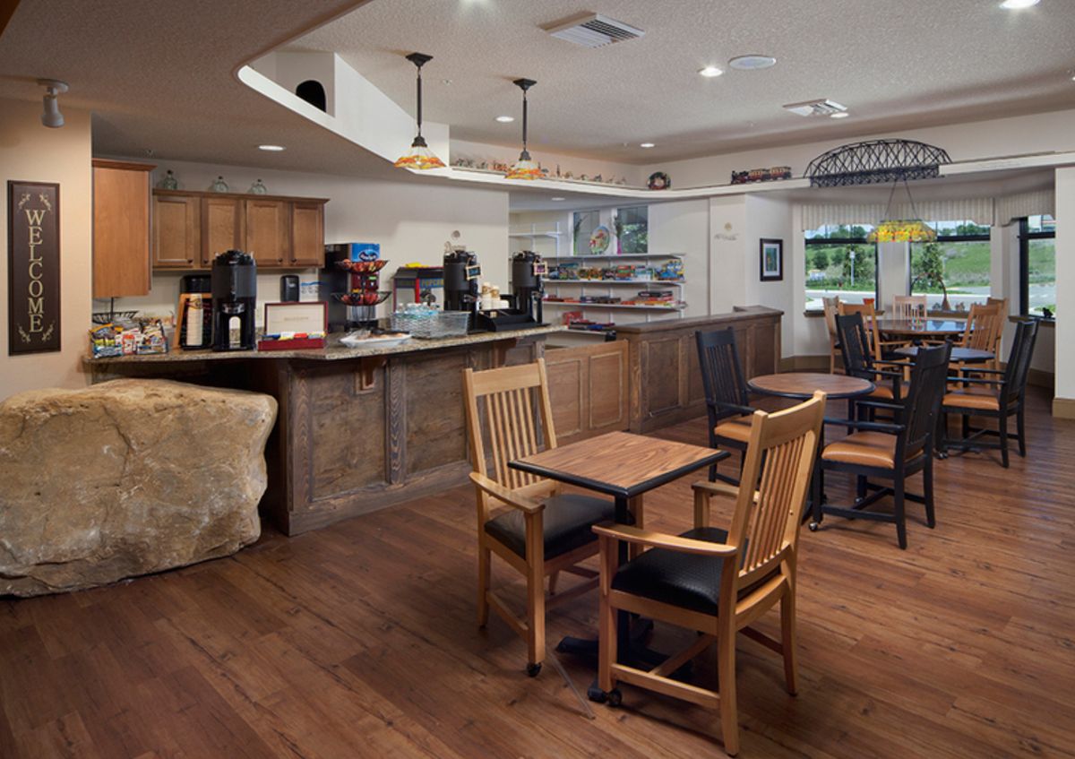 A cozy cafe interior with wooden furniture and a welcoming atmosphere.