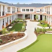 A modern courtyard with well-maintained landscaping and a central pathway.