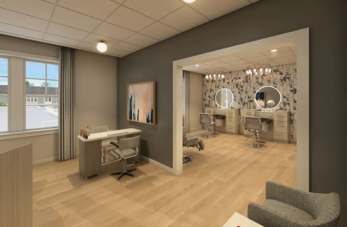 A modern and elegantly designed beauty salon interior with styling chairs and mirrors.