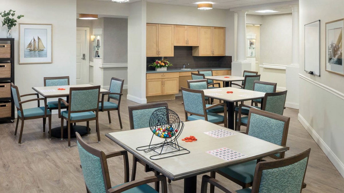 A community room set up for a bingo game with tables and chairs.