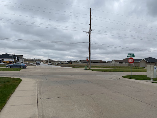 A quiet intersection on a cloudy day, highlighting the suburban landscape.