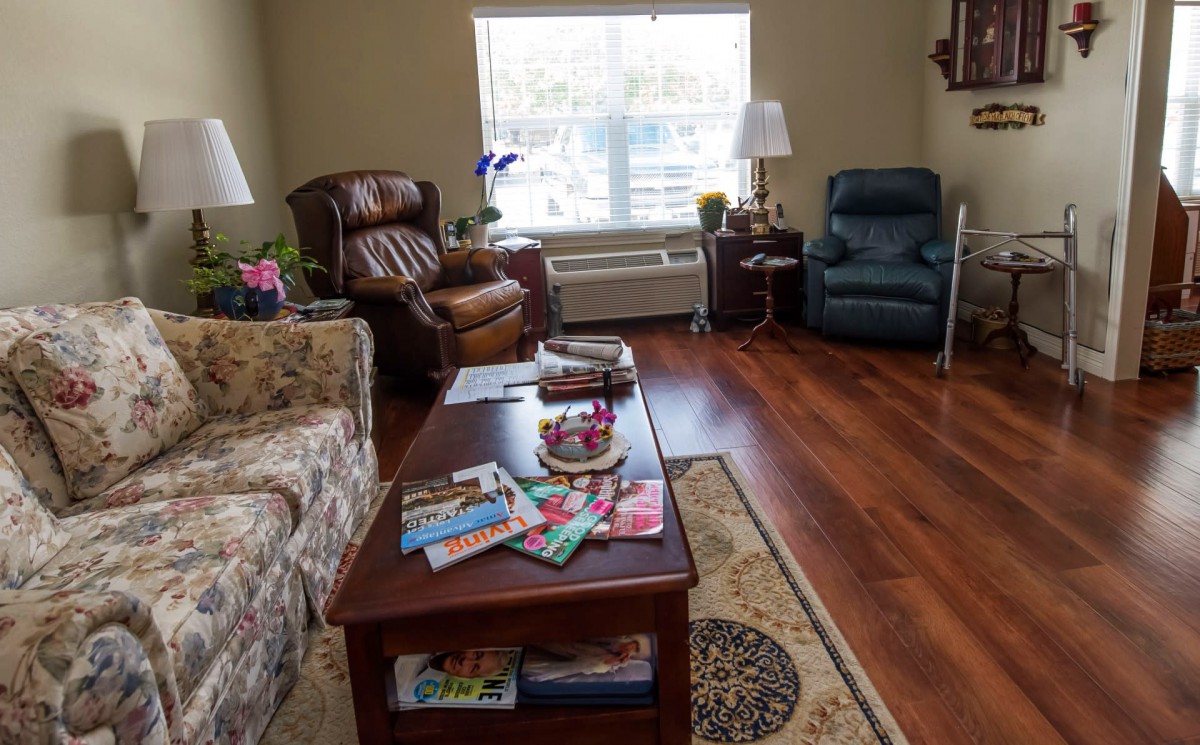 A cozy living room with comfortable seating and a variety of magazines on the coffee table.