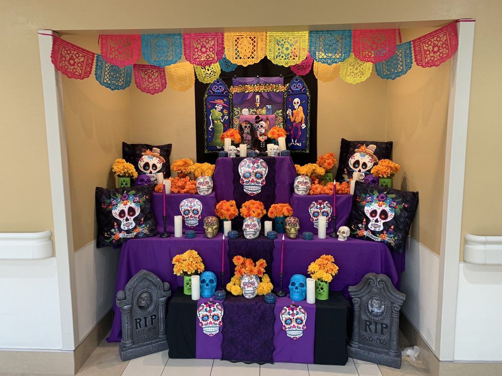 A vibrant Day of the Dead altar decorated with skulls, marigolds, and colorful papel picado.